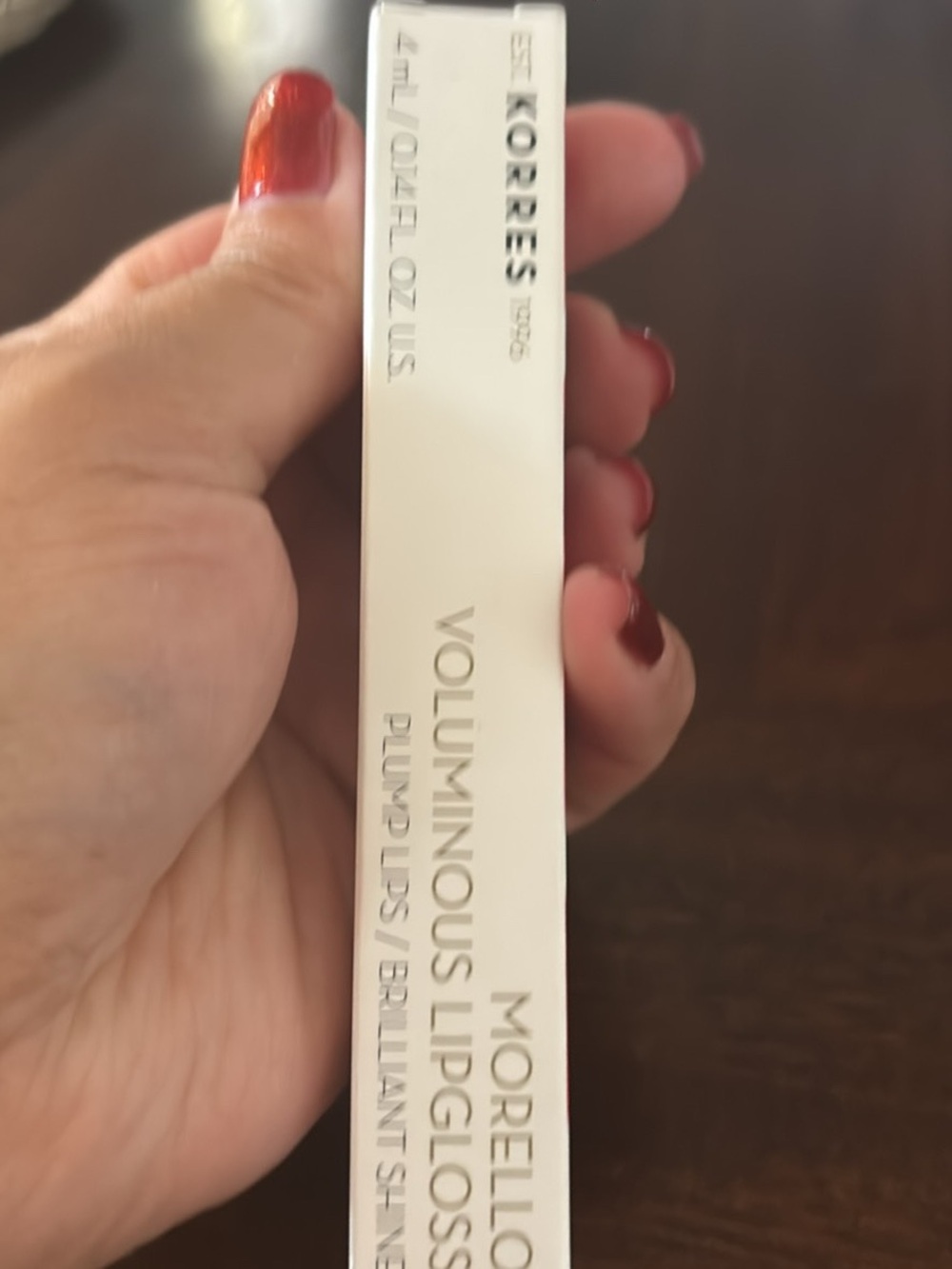 BOODY Lip Gloss - Shiny White Packaging with Red Nails Visible